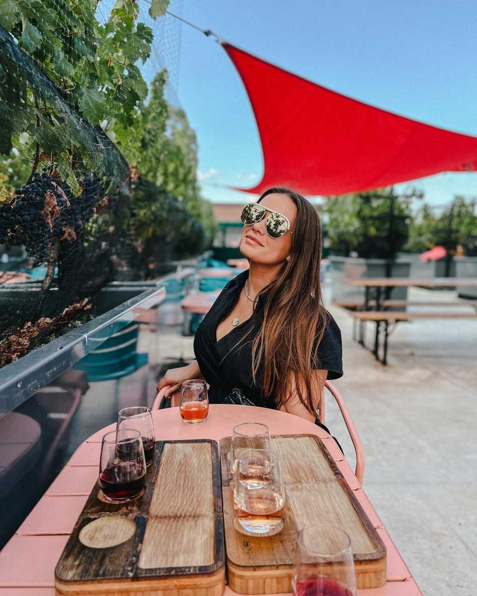A woman having drinks at Rooftop Reds in New York City
