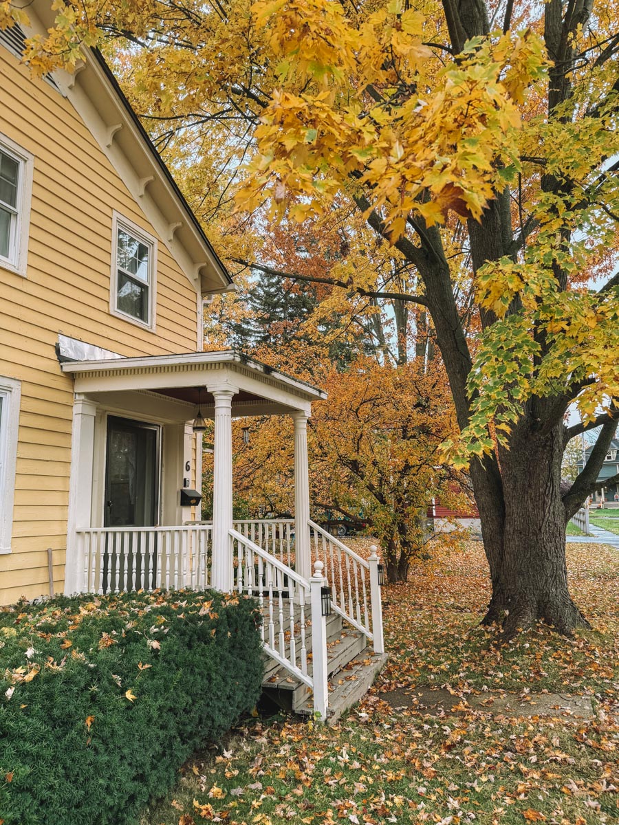 A yellow cute home rental in Seneca Falls in fall