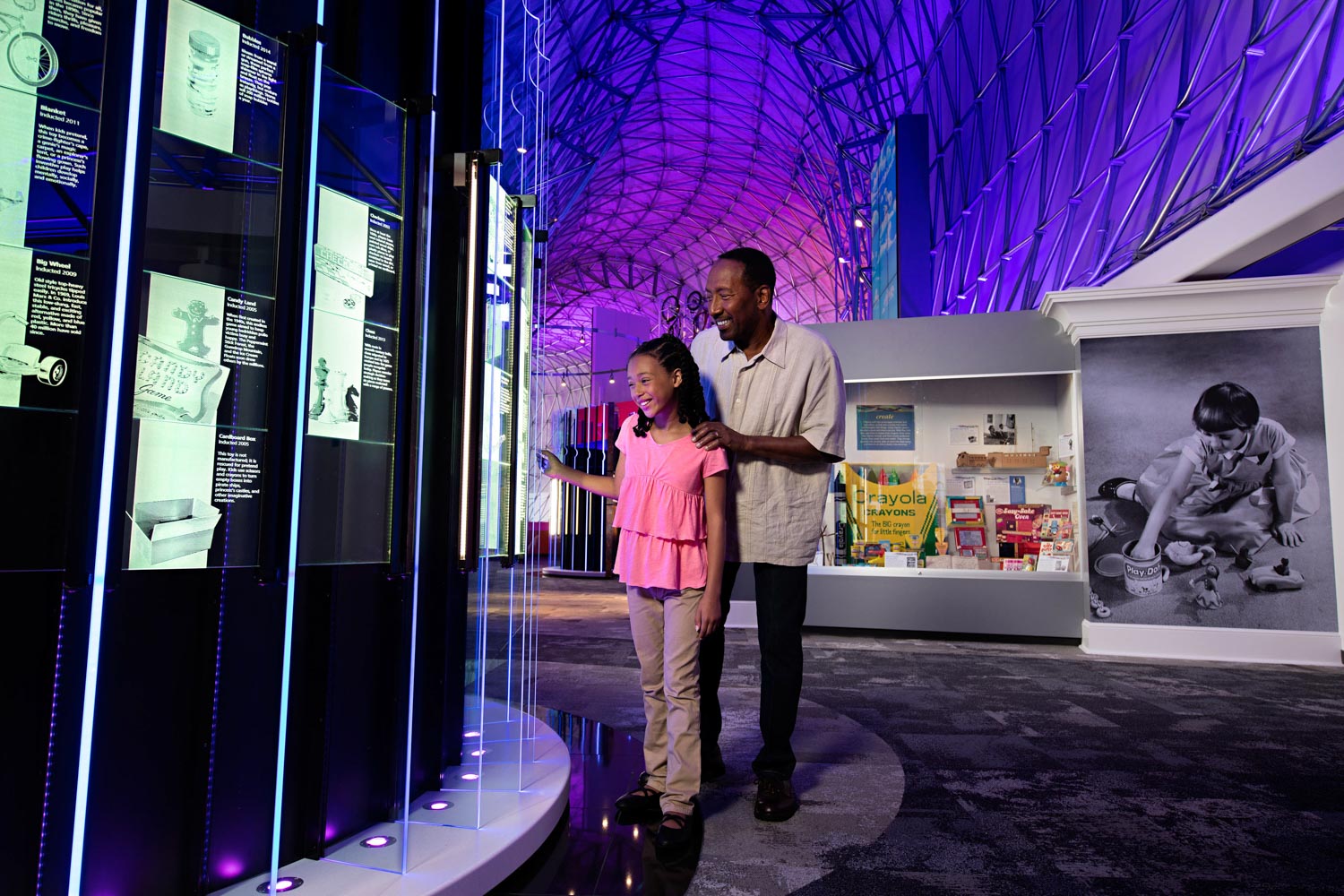 A female kid and a man at the Strong National Museum of Play in Rochester, New York